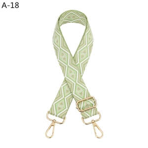 Detail of green diamond pattern woven shoulder strap with gold metal lobster clasps