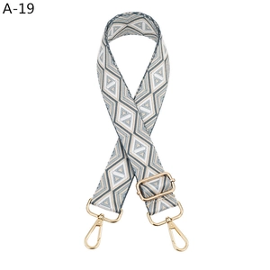 Close-up of a wide adjustable bag strap with vintage geometric rhombus woven pattern