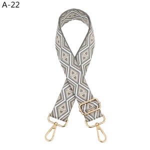 Adjustable wide jacquard shoulder strap with geometric diamond pattern and gold hardware