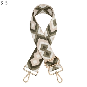 Detail of olive green and beige geometric diamond embroidery on adjustable bag strap