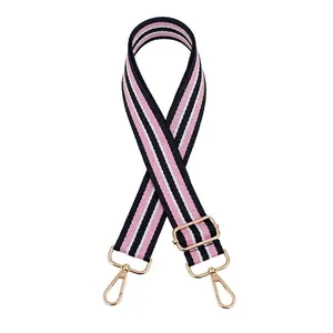 Detailed view of pink, white, and navy striped woven bag strap with gold metal hooks