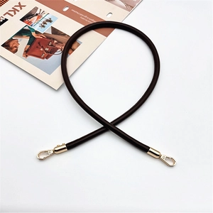 Detail of dark brown leather handbag strap with gold swivel snap hooks for DIY bags