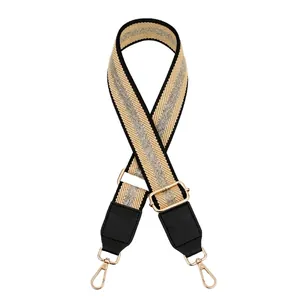 Adjustable beige and silver glitter woven bag strap with black PU leather and gold buckles