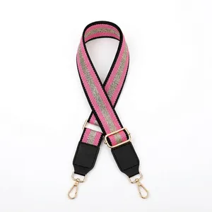 Adjustable crossbody strap with pink and silver glitter twill weave and gold hooks