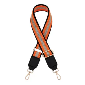 Detail view of orange and grey striped woven bag strap with adjustable gold lobster clips