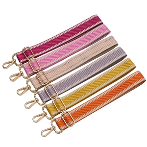Adjustable woven shoulder straps in vibrant colors with golden metal hardware clips