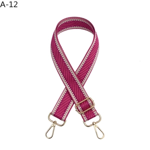 Detail of adjustable rose red herringbone weave strap with pale gold metal swivel hook