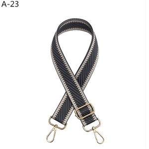 Detail of adjustable chevron weave shoulder strap with polished gold hardware buckles
