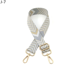 Detail of adjustable gray and white diamond woven strap with light gold metal swivel hooks