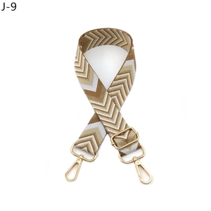 Close-up of geometric arrow pattern polyester strap with golden metal lobster clasps
