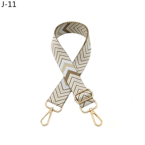 Detail of adjustable bohemian woven shoulder strap with V-pattern and gold metal buckles