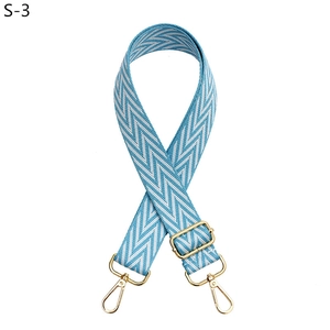 Adjustable woven bag strap with blue and white wave pattern and gold metal lobster clasps