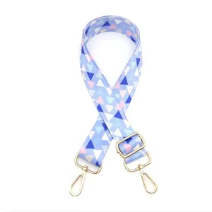 Close-up of adjustable geometric shoulder strap with gold-tone metal lobster clasps