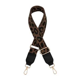 Adjustable leopard print strap with black leather ends and gold metal buckles