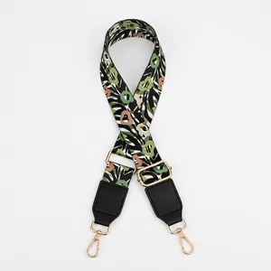 Adjustable woven floral bag strap with black PU leather ends and gold metal lobster hooks