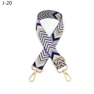 Detail view of purple chevron pattern adjustable bag strap with gold metal lobster hooks