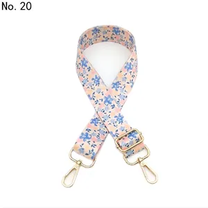 Close-up of adjustable No. 20 floral fabric bag strap with gold metal lobster clasps