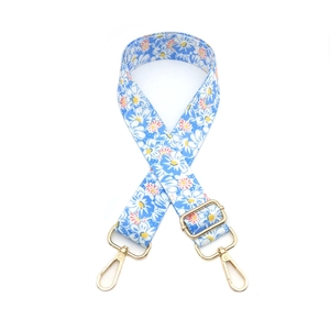 Adjustable blue floral canvas bag strap with daisy print and gold metal swivel hooks