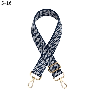 Detail view of blue and white wave jacquard strap with gold-tone lobster clasps