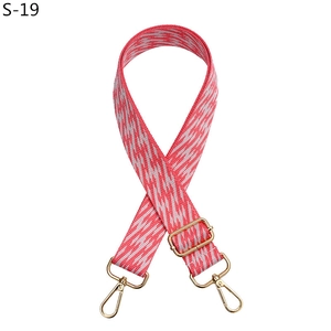Adjustable woven replacement strap for crossbody bags with pink geometric pattern and gold hooks