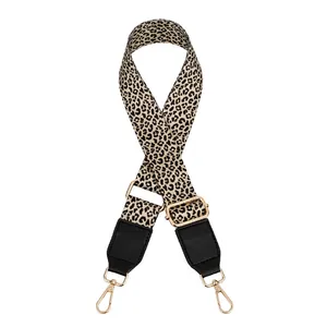 Detailed view of leopard print PU strap with gold metal lobster clasps and black leather ends