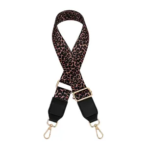 Detail of adjustable leopard print bag strap with golden metal lobster clasps and buckles