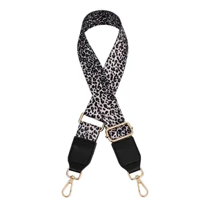 Detail of adjustable leopard print bag strap with golden lobster clasps and black leather ends