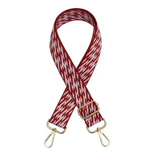 Adjustable red and white geometric patterned nylon wide shoulder strap with gold hooks