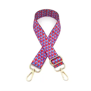 Close-up of colorful geometric pattern bag strap with gold metal lobster clasps