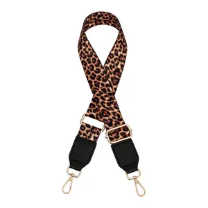 Detail of adjustable leopard print bag strap with black leather ends and gold metal buckles