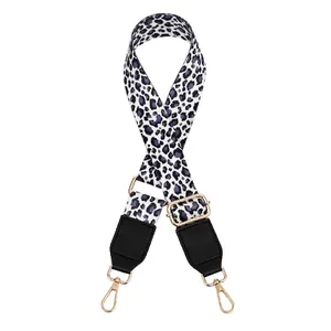 Detail of adjustable leopard print bag strap with gold metal hooks and black leather ends