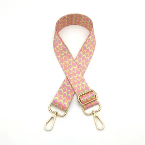 Detailed view of colorful woven nylon bag strap with golden lobster clasps and metal buckle
