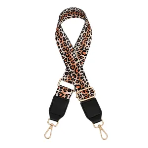 Close-up of leopard print wide replacement bag strap with golden metal swivel hooks