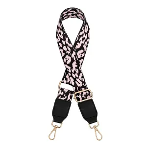 Close-up of leopard print PU leather bag strap with gold metal buckles and lobster clasps