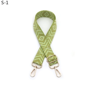 Close-up of adjustable green and white diamond pattern wide strap with gold-tone hardware