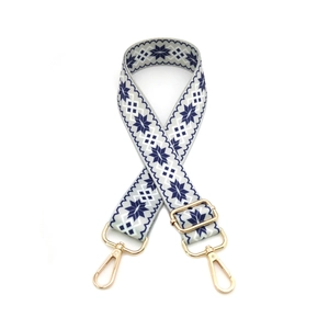 Adjustable crossbody shoulder strap with blue snowflake patterns and gold metal lobster clasps