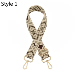 Detail of bohemian jacquard woven bag strap with golden metal swivel hooks and buckles