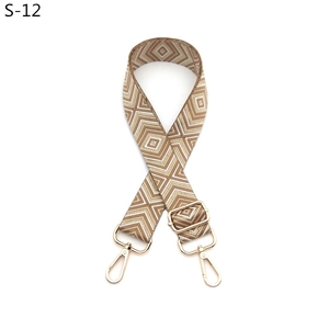 Detail of adjustable geometric diamond pattern bag strap with gold lobster clasps