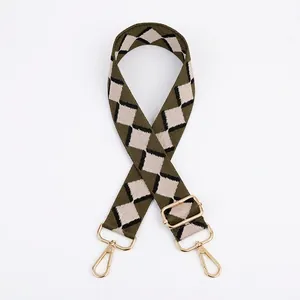 Close-up of army green jacquard bag strap with argyle pattern and gold metal hooks