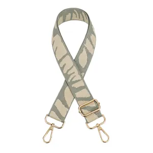 Detailed view of adjustable jacquard replacement strap with gold lobster clasps