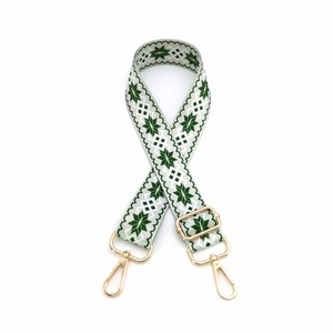 Detail of adjustable geometric strap with gold lobster clasps and Nordic pattern
