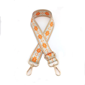 Detail of orange and grey geometric star pattern strap with gold metal hooks