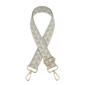 Detail of green geometric jacquard bag strap with golden lobster clasps and buckles