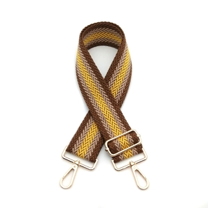 Adjustable wide woven bag strap with brown and yellow herringbone pattern and gold hooks
