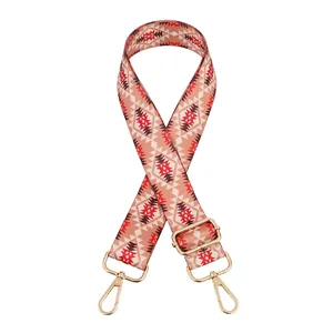 Detail of bohemian geometric woven bag strap with golden metal lobster clasps and buckle