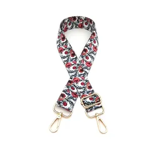 Adjustable crossbody strap featuring floral print and polished gold metal lobster clasps