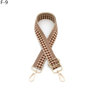 Detail of adjustable checkerboard shoulder strap with gold-tone swivel lobster clasps