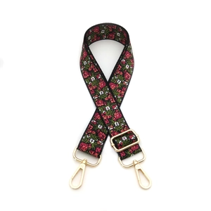 Adjustable floral pattern bag strap with golden metal swivel hooks and black webbing