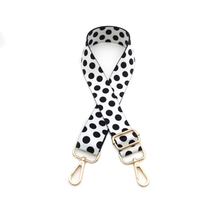 Adjustable wide replacement shoulder strap with classic black and white polka dot pattern
