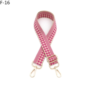 Close-up of pink checkered woven shoulder strap with adjustable golden metal buckle